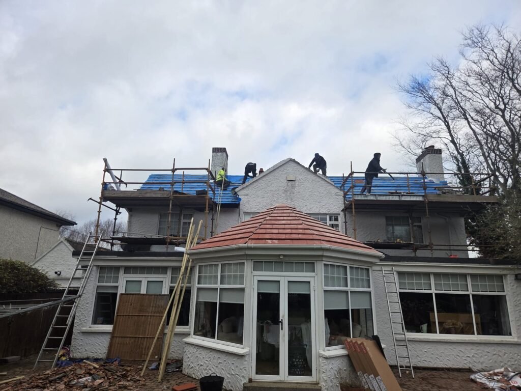 Re-roof in progress above a conservatory