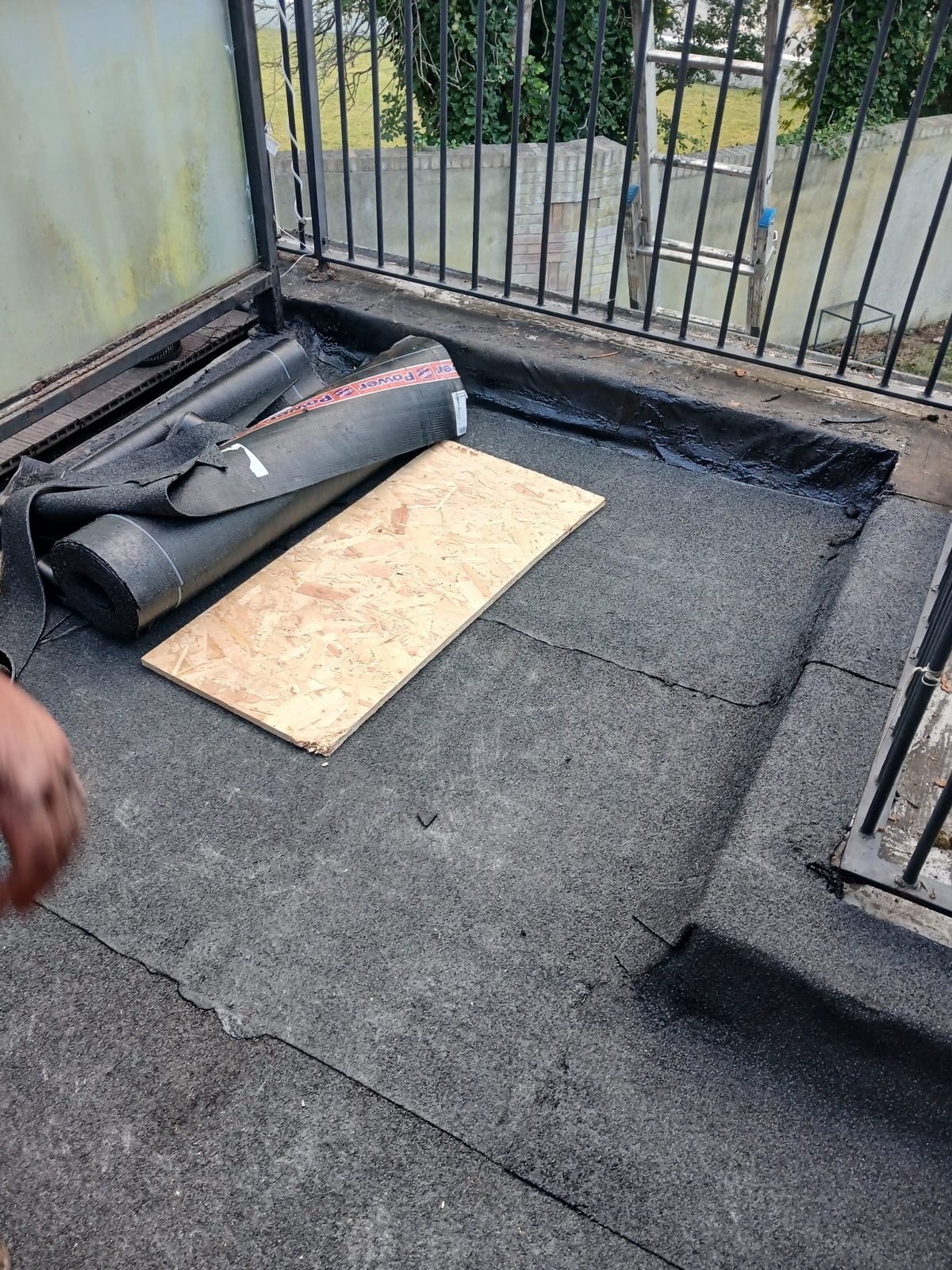 New felt being laid on a flat roof